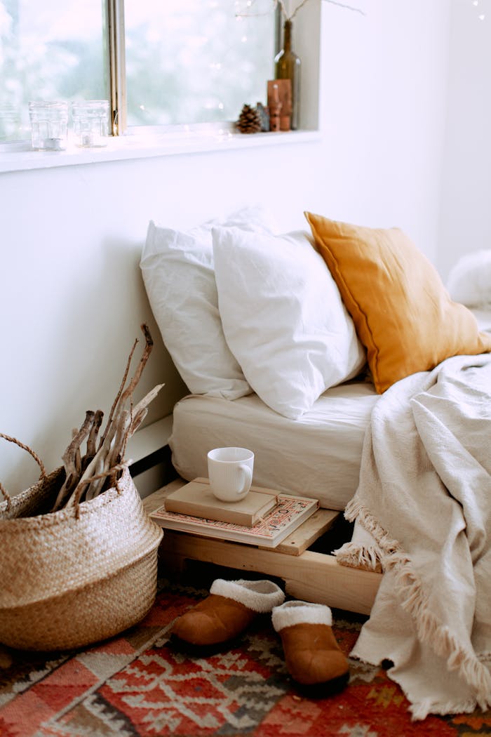 Crafting Captivating Headlines: Your awesome post title goes here A cozy bedroom setup featuring pillows, a blanket, and warm-toned decor.